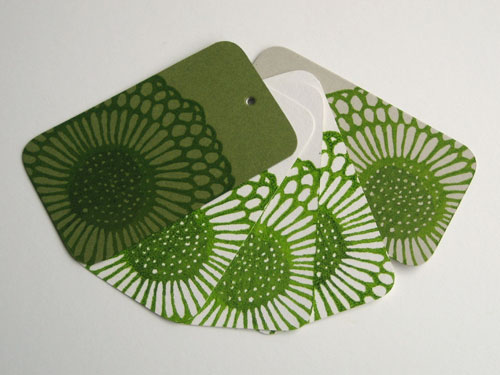 Gift tags with the geranium gocco'd on white, cement and moss cardstock
