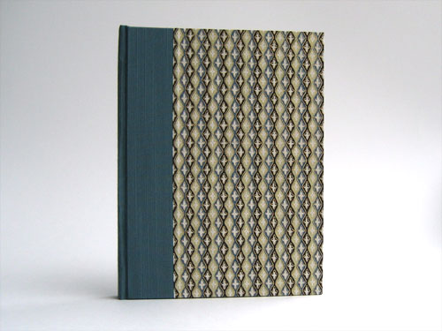 Front view: Chiyogami paper with black, teal and gold diamonds and stripes, teal bookcloth