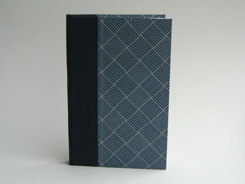 Front view: navy blue paper with silver lines, and navy bookcloth