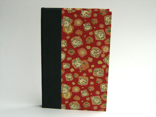 Front view: red paper with a mosaic of gold and green and white dragons, and dark green book cloth