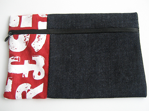 Denim pencil case with a stripe of red and white alphabet screen-printed fabric