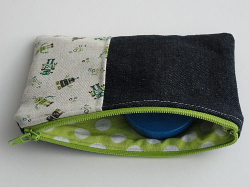 Small zippered pouch in denim with a patch of linen robot print fabric, lined with lime-green and white polkadot fabric