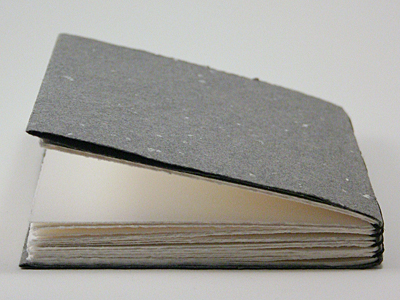 Head detail on the largest book, showing the folded cover
