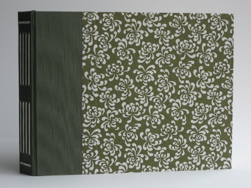 The cover paper has large white flowers on an olive background that matches the bookcloth