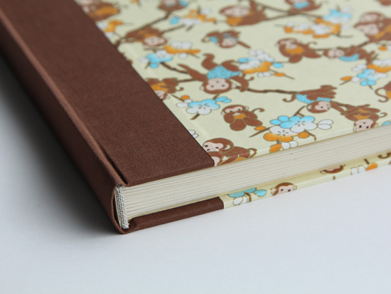 Detail view of brown book cloth and monkeys cover paper