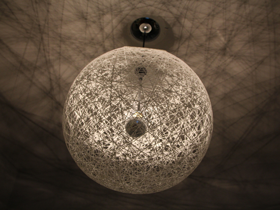 Light fixture of white string wound randomly into a sphere